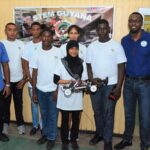 Director of the Sports, Mr. Christopher Jones (first, right) and the team with their robot